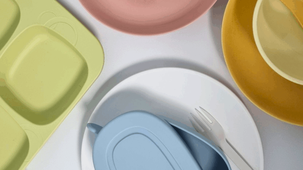 a bunch of different colored plates on a white surface